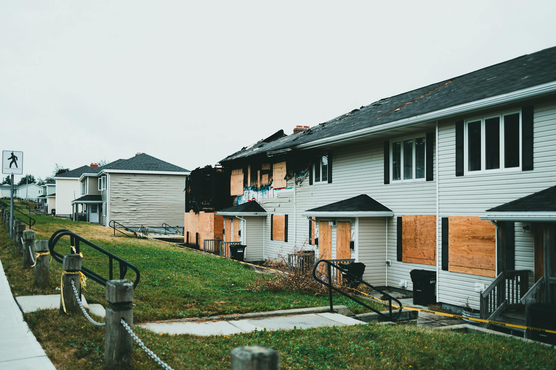 Fire-damaged homes with boarded windows